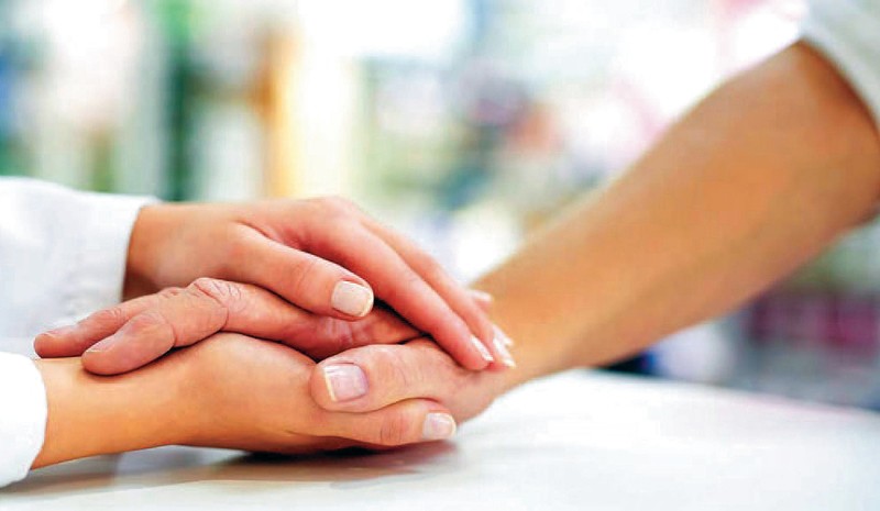 Two hands holding gently together