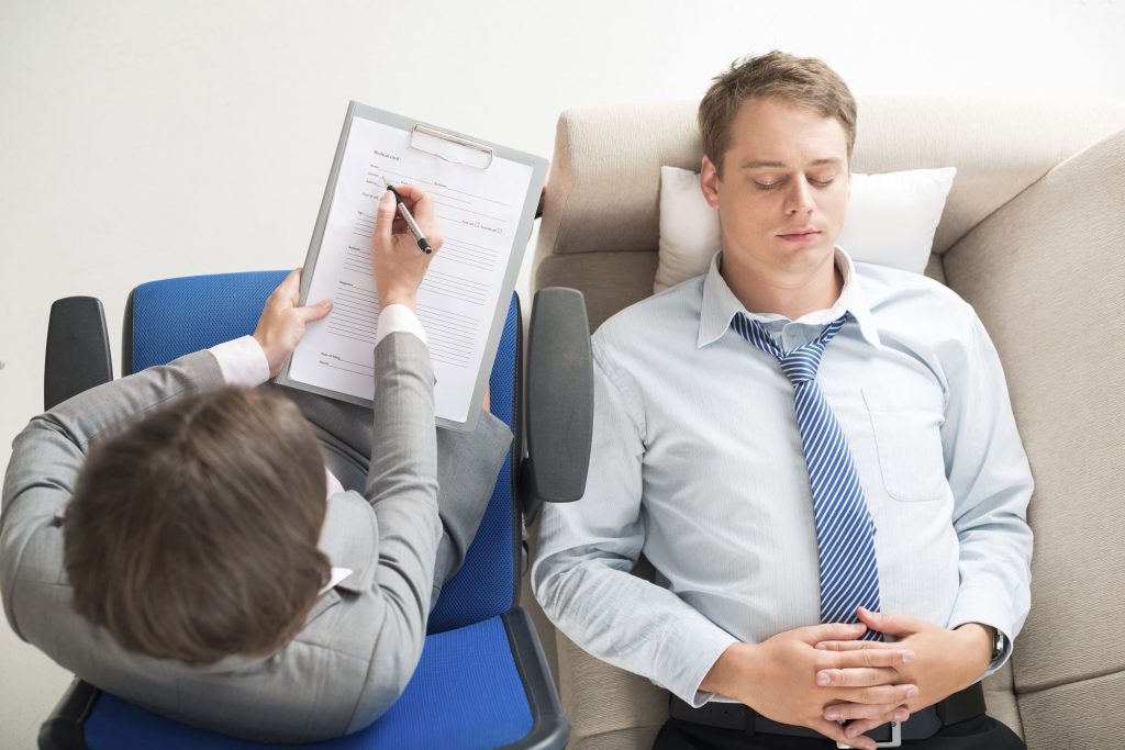 Therapist taking notes during session.